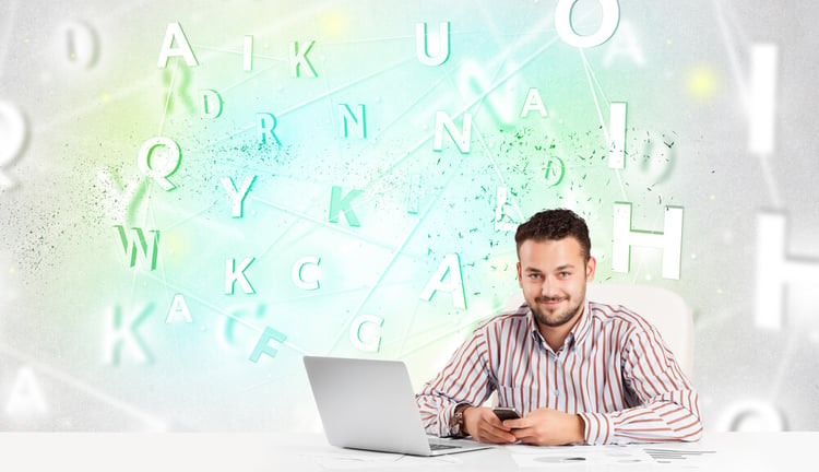 Business man at white desk with green word cloud_seo-opt
