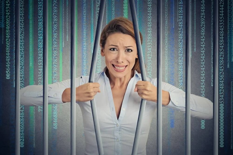 Stressed desperate angry businesswoman bending bars of her digital prison binary code cell. Life limitations, law violation infringement internet addiction consequences concept. Face expression_seo-opt-1