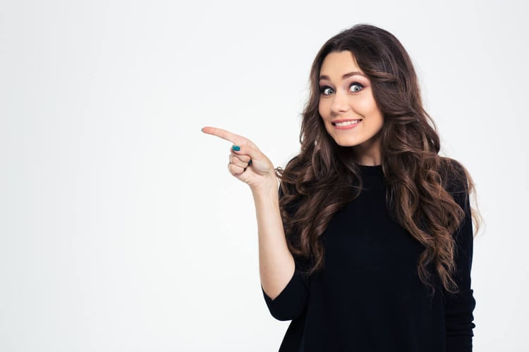 Portrait of a smiling girl pointing finger away isolated on a white background_seo-opt